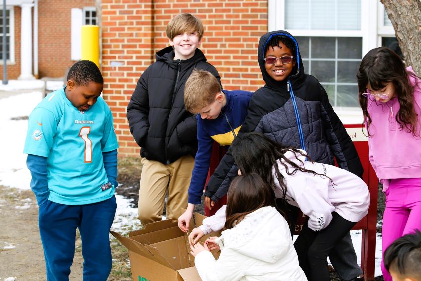 A group of Fifth Grade students at Moorestown Friends School collecting organic material to make their own compost